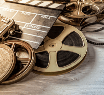 Reels of film on a wood background