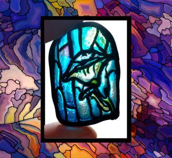 Stained glass background. White box w/ black border and fingers holding a small stained glass piece.