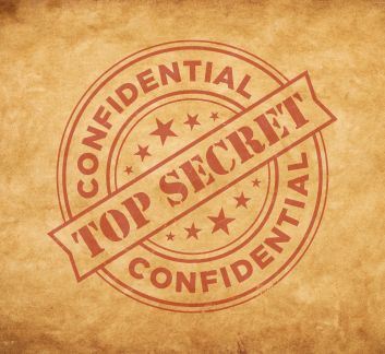 Tan background with red stamped markings that say 