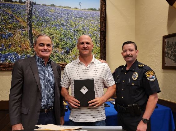 Three people grouped together, smiling at the camera