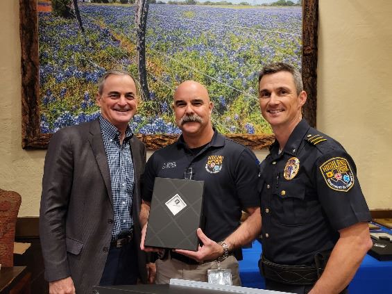 Three people grouped together, smiling at the camera